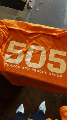 an orange shirt that says search and rescue group