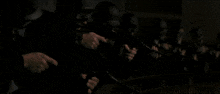 a group of soldiers are firing their guns in a dark room