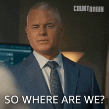 a man in a suit and tie is asking where are we