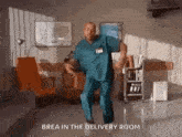 a man in a scrub suit is dancing in a hospital room .
