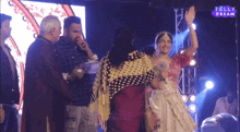 a group of people standing in front of a screen that says telly dream on it
