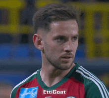 a soccer player wearing a shirt that says ' ettigoat ' on the front