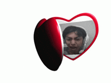 a heart shaped mirror with a picture of a man in headphones on it