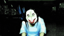 a woman in a blue shirt is wearing a joker mask .