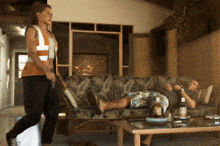 a man laying on a couch next to a woman