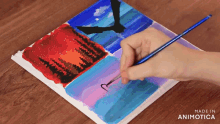 a person is painting a picture with the words made in animotica on the bottom right
