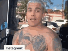 a shirtless man with a tattoo on his chest is standing in front of a door with instagram written on it