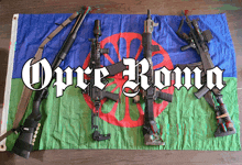 a flag with guns on it that says opre roma