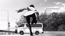 a black and white drawing of a man running towards a van