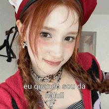 a girl with red hair is wearing a red hat and a necklace with the words eu quando sou da nalu written on it