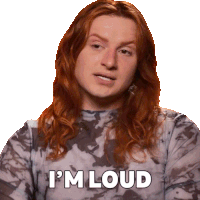 a woman with long red hair is wearing a tie dye shirt and says i 'm loud