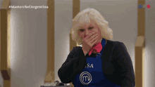 a woman wearing an apron with a m on it