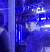 a man is standing in a dark room with blue lights and a sign that says ice