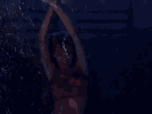 a woman in a red top and red skirt is dancing in the snow .