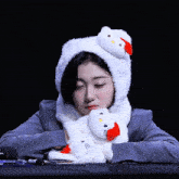 a girl wearing a hello kitty hat and scarf