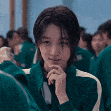 a girl with a nose ring is wearing a green jacket with white stripes