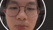 a close up of a person 's face with glasses and a hat