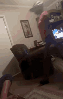 a living room with a picture on the wall and a tv