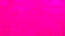 a large statue of a woman 's face is surrounded by pink balls