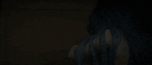 a person with blue hair is holding another person 's hand
