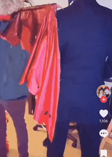 a man in a suit is standing next to a woman in a red cape with a red heart on the bottom right