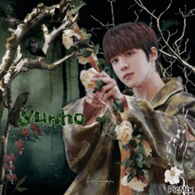 a picture of a young man holding flowers with the name yunho on the bottom