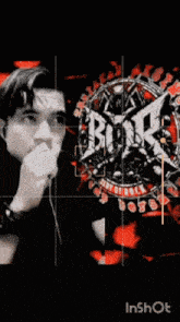 a man is standing in front of a logo for a band called brick boys
