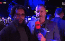 a man holding a microphone that says ' owc ' on it