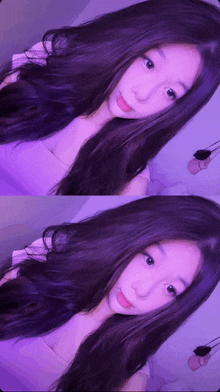 a girl with long purple hair is taking a picture of herself