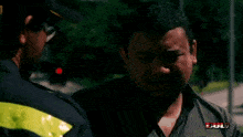 a man talking to another man with the word pukul visible