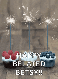 three cupcakes with sparklers and the words happy belated betsy on the bottom