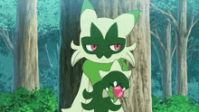 a green and white cat with red eyes is standing next to a tree in a forest