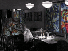 a man is painting a picture in a dark room with stained glass windows