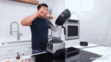 a man is pouring something into a blender in a kitchen with the words made in animatica at the bottom