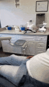 a man sits in a dental chair with a caution sign on the wall