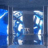 a man is walking down a runway in front of a large screen