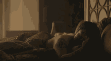a shirtless man with a tattoo on his arm laying on a bed