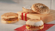 an advertisement for tim selects shows a classic bagel and cream cheese spread on a cutting board