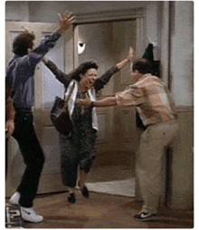 a man and a woman are giving each other a high five .