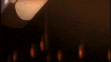 a close up of a person 's leg in a dark room with a black background .