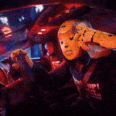a man in a crash helmet is holding a stack of money