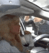 a woman is drinking wine while driving a car
