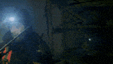 a person is holding a long stick in a dark room .