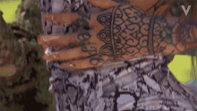 a woman with a lot of tattoos on her arms and hands