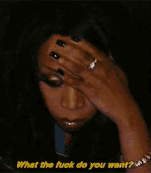 a woman is covering her face with her hand and asking what the fuck do you want
