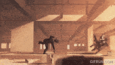 a gif from gifrun.com shows a man falling from a chair