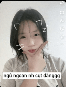 a girl with a cat ear on her head and a caption that says " ngoan nh cut danggo "