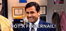 a man in a suit and tie is making a funny face and saying `` not a fingernail ! ''