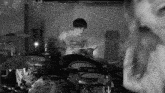 a man playing drums in a room with a shirt that says ' burton ' on it