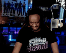 a man wearing a shirt that says filthy casual is yawning